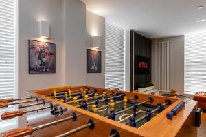 a game room with a large billiard table at MK CITY CENTRE, THE DIAMOND SUITE, FREE Parking Space, PREMIUM SPACIOUS Apartment with FOOSBALL TABLE in Milton Keynes