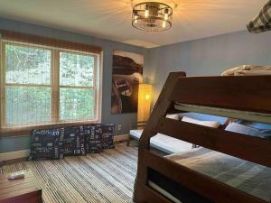 a bedroom with two bunk beds and a window at Lake House with private beach in Putnam