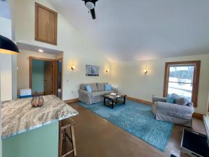 a living room with a couch and a table at Fat Sheep Farm & Cabins in Windsor