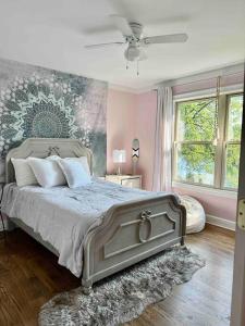 a bedroom with a large bed with a painting on the wall at Lake House with private beach in Putnam