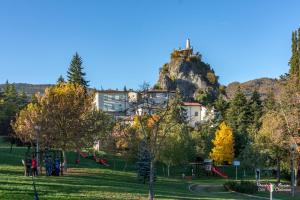 a building on top of a hill with a playground at Antica Locanda La Posta in Gaggio Montano