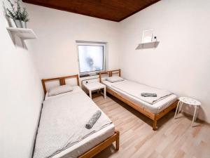 a bedroom with two beds and a window at 3 Apartments in 1 location in Prague
