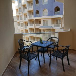 a table and chairs on the balcony of a apartment at Florenza Khamsin 83 quarterm. Arpartment in Hurghada
