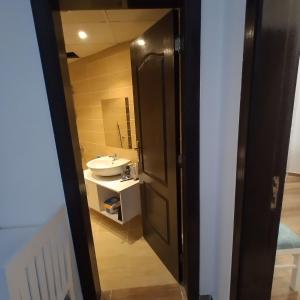 a bathroom with a sink and a toilet and a mirror at Florenza Khamsin 83 quarterm. Arpartment in Hurghada