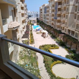 a view of a pool from a balcony of a building at Florenza Khamsin 83 quarterm. Arpartment in Hurghada