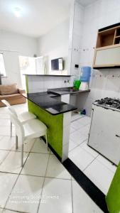 a white and green kitchen with a counter and a stove at Kitnet praia de Atalaia, Aracaju - Sergipe in Aracaju +8 photos