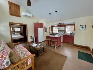 a living room with a couch and a kitchen at Fat Sheep Farm & Cabins in Windsor