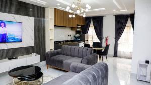 a living room with a couch and a table at Delight Apartments - Oniru VI in Lagos