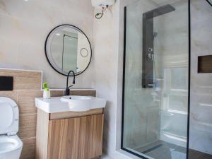 a bathroom with a sink and a shower at Delight Apartments - Oniru VI in Lagos