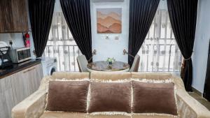 a living room with a couch and a table at Delight Apartments - Oniru VI in Lagos