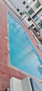 a large swimming pool next to a building at Homely 2-Bedroom at Victoria Place in Dar es Salaam