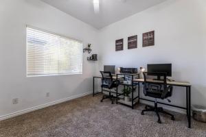 a room with a desk and chairs and a window at The Nest at Woodside: Lux LA getaway + office/spa in Santa Clarita