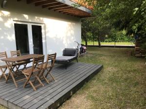 a wooden deck with a table and chairs in a yard at U kota Białogóra in Białogóra