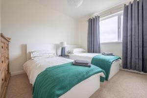 a bedroom with two beds and a window at Farnetra Lodge in Clogher