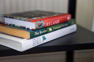 three books stacked on top of each other on a table at Farnetra Lodge in Clogher