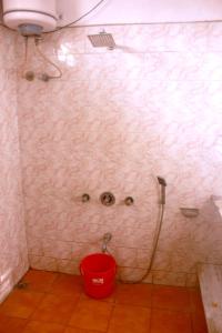 a bathroom with a shower with a bucket in it at Perfect Homestay Ujjain in Ujjain
