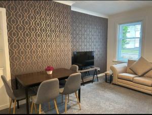 a living room with a table and a couch at Camisila in Campbeltown