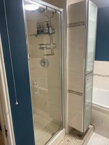 a shower with a glass door in a bathroom at Home away from Home in Cross Gates