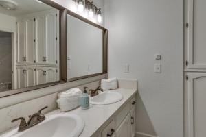 a bathroom with two sinks and a large mirror at Pet-Friendly Coarsegold Vacation Rental with Deck! in Coarsegold +24 photos