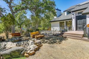 a home with a patio and a house at Pet-Friendly Coarsegold Vacation Rental with Deck! in Coarsegold