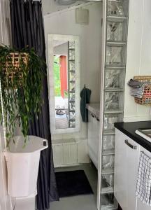 a kitchen with a window and a sink with a plant at Familievennlig hytte ved populært badevann! in Sandefjord