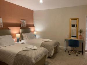 a hotel room with two beds and a mirror at Woodborough Hall in Woodborough