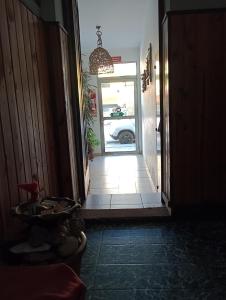 a hallway with a door leading to a car outside at Hostería Cerros Dorados de Cosquín in Cosquín