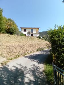 une maison au sommet d'une colline avec une route dans l'établissement Appartamento Il Castagno, à Fosdinovo