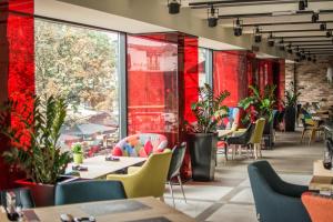 a restaurant with tables and chairs and red walls at Boutique Rooms in Belgrade