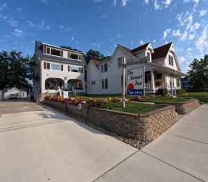 a large white house with a sign in front of it at Sunset Inn in South Haven