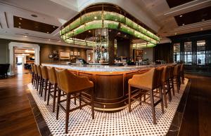 a bar in a restaurant with a bunch of chairs at Gaylord National Resort & Convention Center in National Harbor