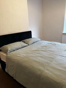 a bed with two pillows on it in a bedroom at Clevedon House in Manchester