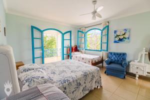 um quarto azul com uma cama e uma cadeira em Linda casa de fazenda no interior de SP em Elias Fausto