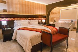 ein Hotelzimmer mit einem Bett und einer Badewanne in der Unterkunft Altipacha Ayacucho Hotel in Ayacucho