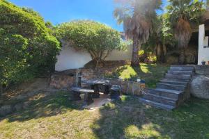 a park with a picnic table and stairs in a yard at SeaViews Holiday Apartment 1 in Cape Town