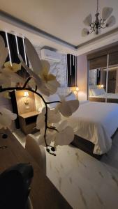 a bedroom with a large bed with a flower on it at Western Gate Residence 1 - Amman, Jordan in Amman