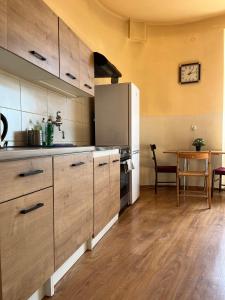 a kitchen with wooden cabinets and a table in a room at Nice room in Old Town Kraków in Kraków