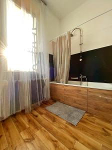 a bathroom with a tub and a sink and a window at Nice room in Old Town Kraków in Krakow