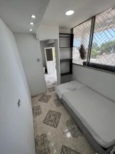 a bed in a room with a large window at Apartamento amoblado CARTAGENA in Cartagena de Indias