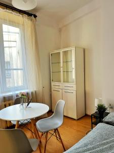 a white table and chairs in a room with a window at Nice room in Old Town Kraków in Krakow