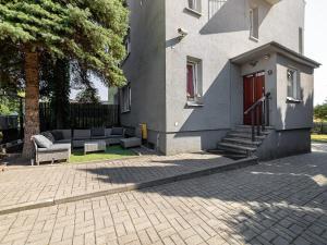 a building with a couch in front of a house at Gościnnie Lublin - Olimp in Lublin