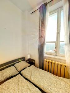 a bedroom with a large bed and a window at Nice room in Old Town Kraków in Krakow