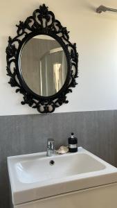 a bathroom sink with a mirror on the wall at Rodzinne miejsce in Kopalino