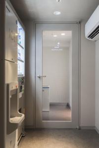 a glass door in a room with a walk in shower at Nagoya Kanayama Hotel in Nagoya