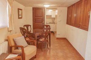 a living room with a dining room table and chairs at Hotel Tàrbena in Tárbena