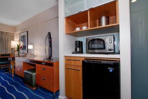 a kitchen with a stove and a microwave at Ocean views Walk to beach Waikiki and mall 1223 in Honolulu