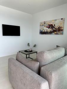 a living room with a couch and a table at Zen Residence in Brist