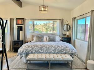 a bedroom with a bed and a large window at NEW Feather Your Nest King bed Casita, Balcony/BBQ, Amazing views & great Location! Dog friendly in Prescott