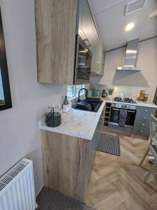 a kitchen with a counter top in a room at Waterfoot Lodge in Little Habton