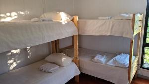 three bunk beds in a room with a window at Quinta Germania in Garupá
